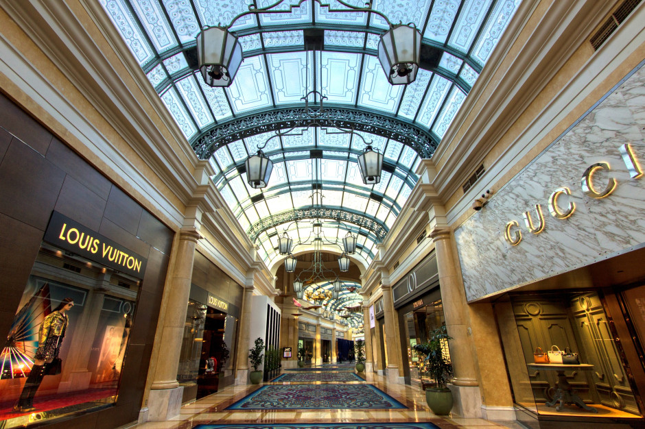 Luxury boutiques in a shopping mall - Gucci, LV / Shutterstock