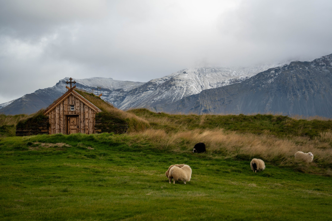 A roofed church in a green valley in Iceland / Shutterstock / Ron Costi